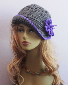 a mannequin head wearing a gray and purple hat