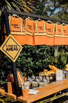 there is a work zone sign on the table with construction signs and other items around it