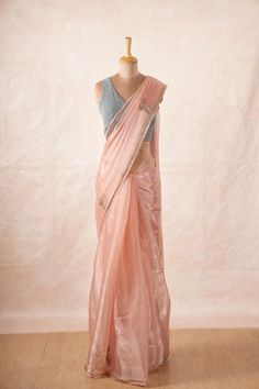 The sheer beauty of this saree is unparalleled, with its delicate and lightweight chinon chiffon fabric that drapes effortlessly to create a mesmerizing silhouette. Material: Chinon Chiffon Embellishments: Motifs, borders and pallu embellished with Swarovski stones and tassels. Color: Light Pink Saree Size: 1.12 x 5.6 metres Blouse: Attached blouse material  (0.88 metres approx) Display: The mannequin is draped in our pink chinon chiffon saree with our grey glitter blouse. Colors Available: 3 Dola Silk Pre-draped Saree For Party Wear, Party Wear Saree With Pallu, Pink Georgette Saree With Zari Weaving, Art Silk Pre-draped Saree With Sheer Dupatta, Party Wear Georgette Saree, Chanderi Party Wear Saree With Self Design, Party Wear Chanderi Saree With Self Design, Chanderi Saree With Self Design For Party, Pink Saree With Sheer Dupatta