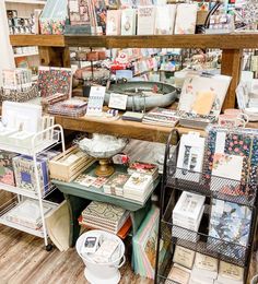 a room filled with lots of different types of cards and books on shelves next to each other