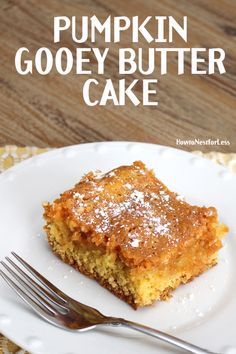 a piece of pumpkin gooey butter cake on a white plate with a fork next to it