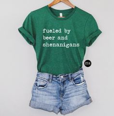 Fueled By Beer And Shenanigans, St Patricks Shirt, Beer Shirt, Cute St Patricks Day Shananigans Shirt, Funny Matching Irish Drinking Shirts This listing is for ( 1 ) top of your choice in the following styles: womens tank OR unisex t-shirt Tanks available in: military green, mint green, or kelly green. MILITARY & KELLY green tanks will have WHITE lettering. MINT tanks will have GREEN lettering. T-shirts available in: kelly green, heather grass, or white. GREEN shirts will have WHITE lettering. W St. Patrick's Day Cotton Crew Neck Tops, Cotton Crew Neck Top For St. Patrick's Day, Cotton Top With Letter Print For St. Patrick's Day, St Patricks Shirt, Green Shirts, Funny Matching, Green Mint, Drinking Shirts, Green Tank