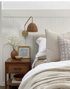 a bed room with a neatly made bed and two nightstands next to each other