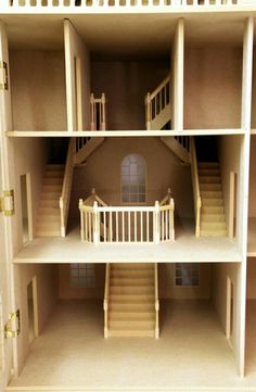 the inside of a doll house with stairs and balconies