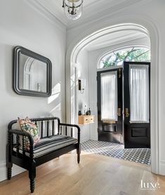 an instagram page with a black and white bench in front of a door, windows and rugs on the floor