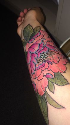 a person with a flower tattoo on their arm