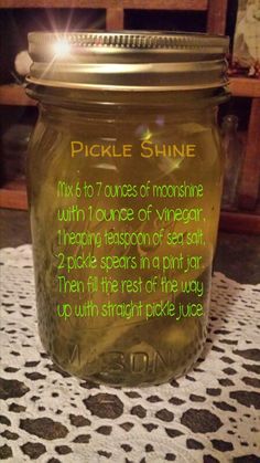 a mason jar filled with pickle shine