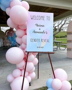 a welcome sign and balloons in front of a tent at a genderal ceremony for the baby