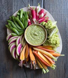 a platter filled with vegetables and dip