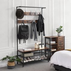 a room with a bed, coat rack and shoes