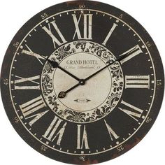 a large black and white clock with roman numerals on it's face