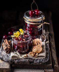 cherries and walnuts in a jar on a table