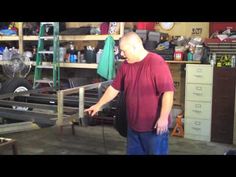 a man is standing in a garage with tools