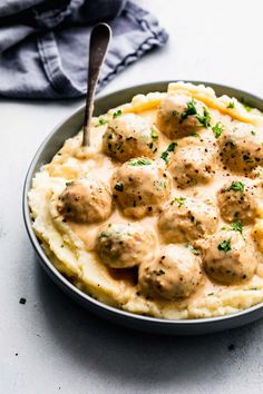 a bowl filled with mashed potatoes and meatballs