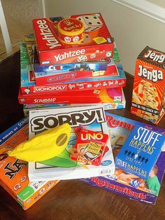 a pile of cereal boxes sitting on top of a wooden table next to a wall