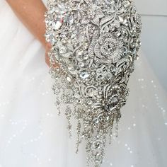 a bride's wedding dress is adorned with crystal beads and sequins,