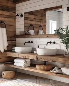 a bathroom with two sinks and towels on the shelf