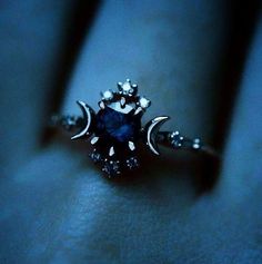 a close up view of a ring with a blue stone