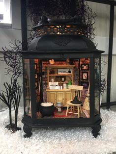 a doll house with furniture and decorations in the front yard, including a desk and chair