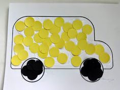 a paper plate with yellow and black circles in the shape of a truck on it