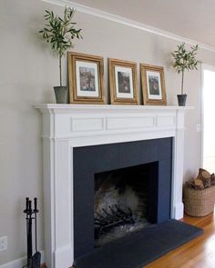 a living room with a fire place and pictures on the mantle