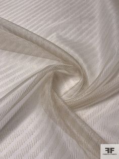 an image of a white fabric textured with lines and stripes on the outside of it