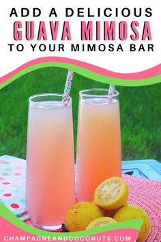 two glasses filled with pink liquid sitting on top of a table next to lemons