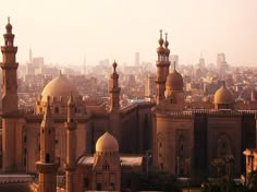 an aerial view of a city with many tall buildings and large towers in the foreground