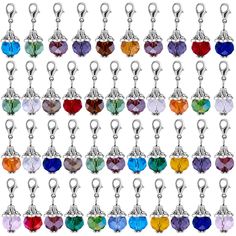 many colors of crystal heart shaped charms on a white background with clippings to the side