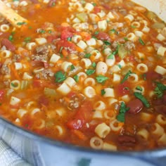 a pot filled with pasta and meat soup