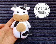 a hand holding a small stuffed cow with a speech bubble above it that says pop & svg pattern