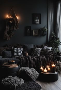 a living room filled with lots of furniture next to a window covered in blankets and candles