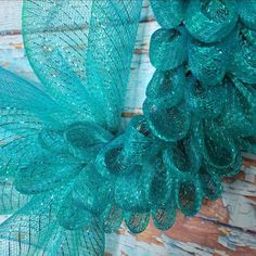 a close up view of some blue mesh material on a wall with wood planks in the background