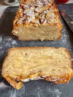 two pieces of bread sitting on top of a cutting board