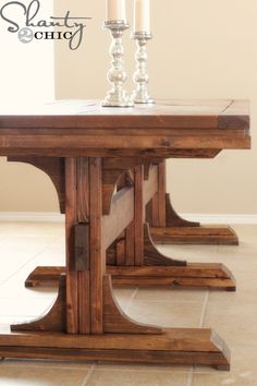 the table is made out of wood and has three legs that are very high on each end