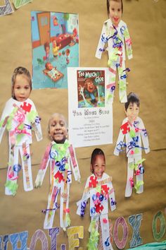 children's paper dolls are displayed on a bulletin board