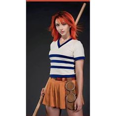 a woman with red hair is holding a baseball bat and wearing a short orange skirt