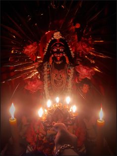 an idol with candles in front of it