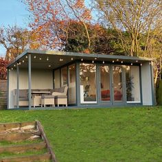 a small house sitting on top of a lush green field