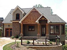 a house with brown shingles and wood trim