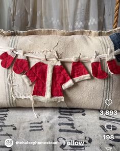 a pillow that has been decorated with red and white hearts hanging from it's sides