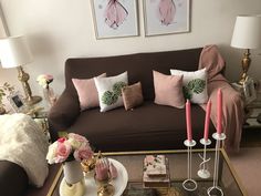 a living room filled with lots of furniture and flowers on top of a coffee table