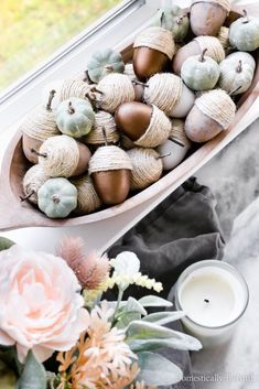 a vase filled with flowers sitting next to a window sill on top of a table