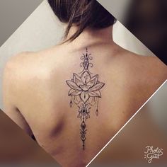 the back of a woman's shoulder with a lotus tattoo on it