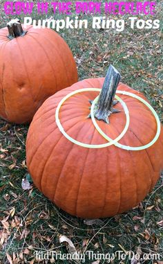 two pumpkins with rings on them sitting in the grass