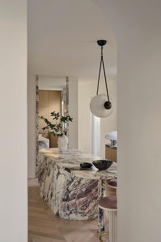 a kitchen with marble counter tops and stools