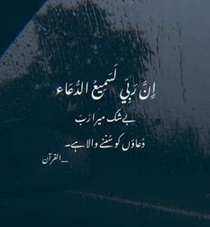 an arabic text written on the side of a car window with rain drops falling down