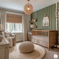 a baby's room with green walls and white furniture, including a crib