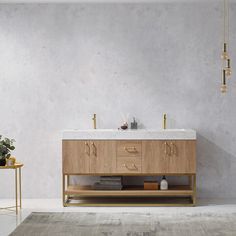 a bathroom vanity with two sinks and gold handles