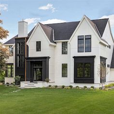 a large white house with black trim and windows